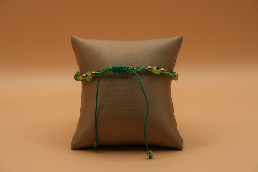 Dangling San Judas lime green evil eye bracelet